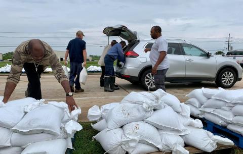 Workers loading sandbags