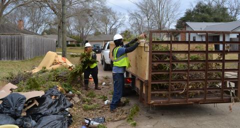 Workers with Southern Wood Products collect tree debris Thursday in the Good Earth subdivision. The contractor has been hired to assist city sanitation workers in collecting the high volume of tree debris throughout the city.