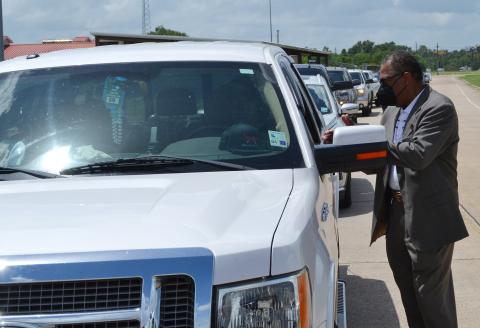 Photo: Alexandria Mayor Jeff Hall visits with a resident waiting to get sandbags Saturday afternoon at the Consolidated City Compound. 