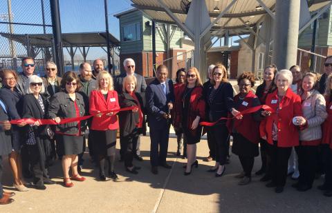 Alexandria Mayor Jeff Hall (center, with scissors) cuts the ribbon Tuesday morning formally re-opening the baseball and softball fields at the rejuvenated Johnny Downs Sports Complex. Joining Mayor Hall are representatives of the Central Louisiana Regional Chamber of Commerce, local officials, representatives of the construction firms that assisted with the repairs and improvements following a December 2019 tornado that destroyed much of the facility, and supporters of youth sports.