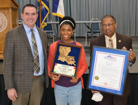 Zaila Avant-garde (center) was honored by Rapides Parish School Superintendent Jeff Powell (left) and Alexandria Mayor Jeff Hall Monday afternoon during a meeting in Alexandria Convention Hall. She was presented with a plaque recognizing her statewide tour as well as a proclamation from Mayor Hall designating Monday, February 21, 2022, as Zaila Avant-garde Day in the city.